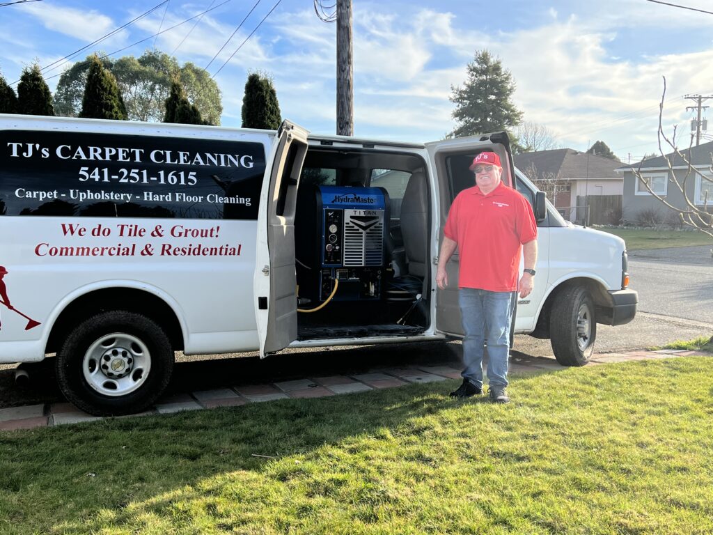 TJ of TJ's Carpet Cleaning standing next to professional van